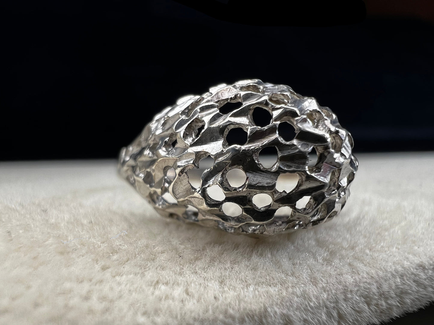This sterling silver ring features a modern design with diamond-cut detailing that creates the timeless look of a classic nugget ring. Its open work adds elegance and depth, offering a unique style that blends contemporary flair with vintage charm for everyday wear.