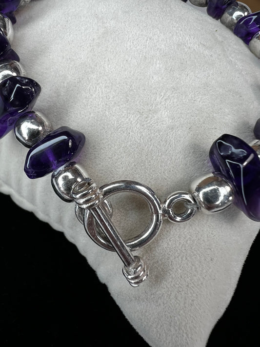 Upgrade your outfit with this elegant bracelet. It features natural amethyst and sterling silver beads secured by a convenient toggle closure.