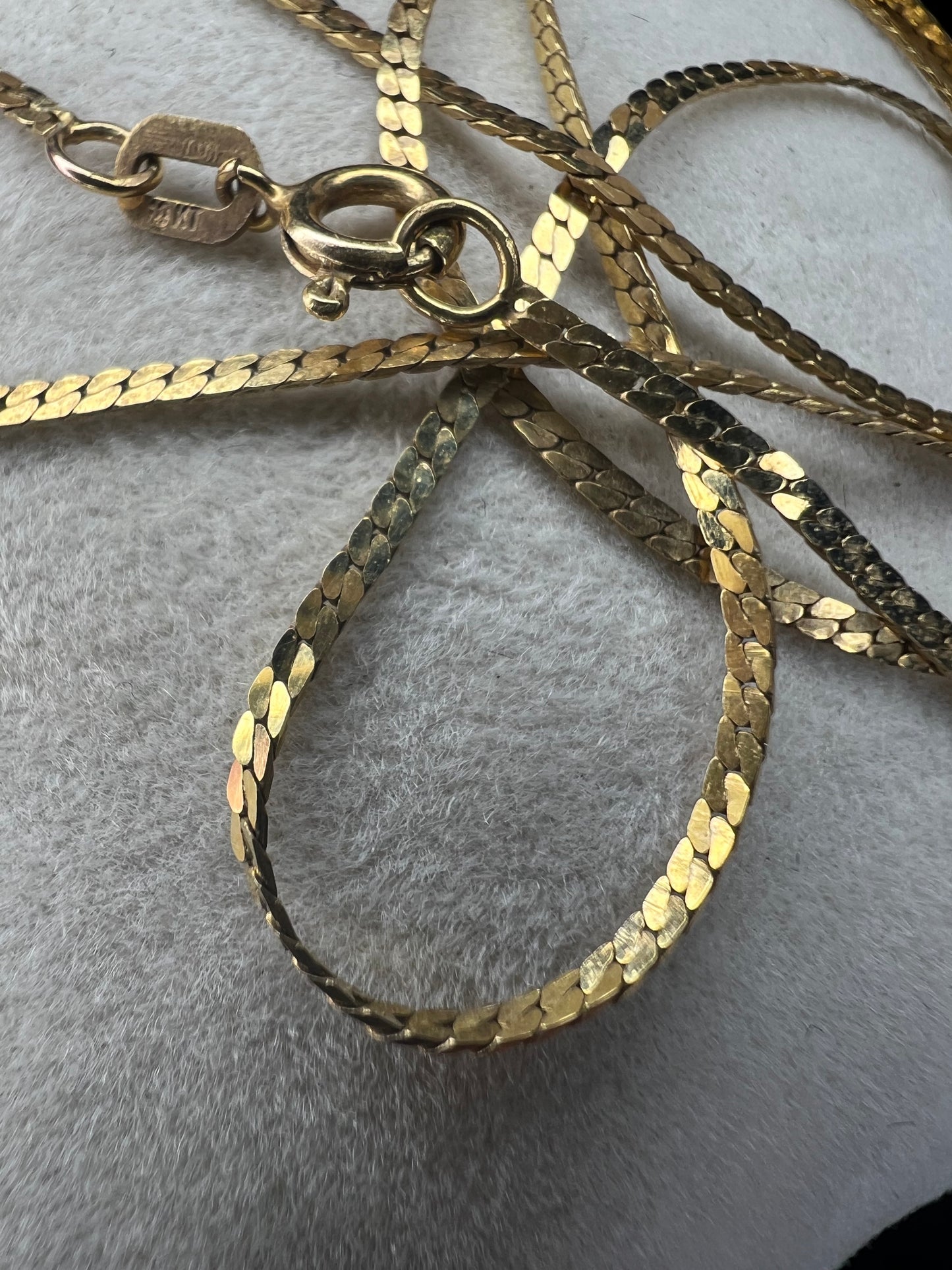 This 10 karat gold necklace is a generous 24 inches in length. It can be worn alone or paired with one of our gold pendants.