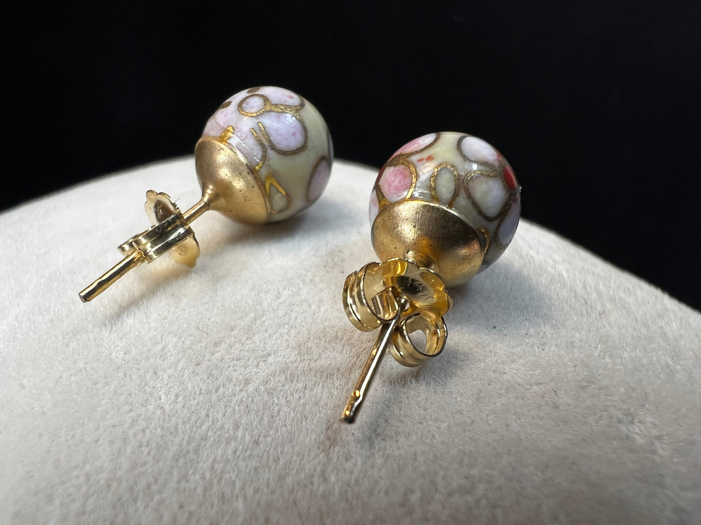 This pair of earrings features an 8 mm cloisonné ball with 14k gold posts and backs. Cloisonné is the art of creating a design on an object by attaching small pieces of wire to a base and filling the compartments with enamel.