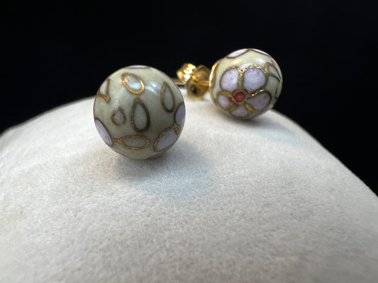 This pair of earrings features an 8 mm cloisonné ball with 14k gold posts and backs. Cloisonné is the art of creating a design on an object by attaching small pieces of wire to a base and filling the compartments with enamel.