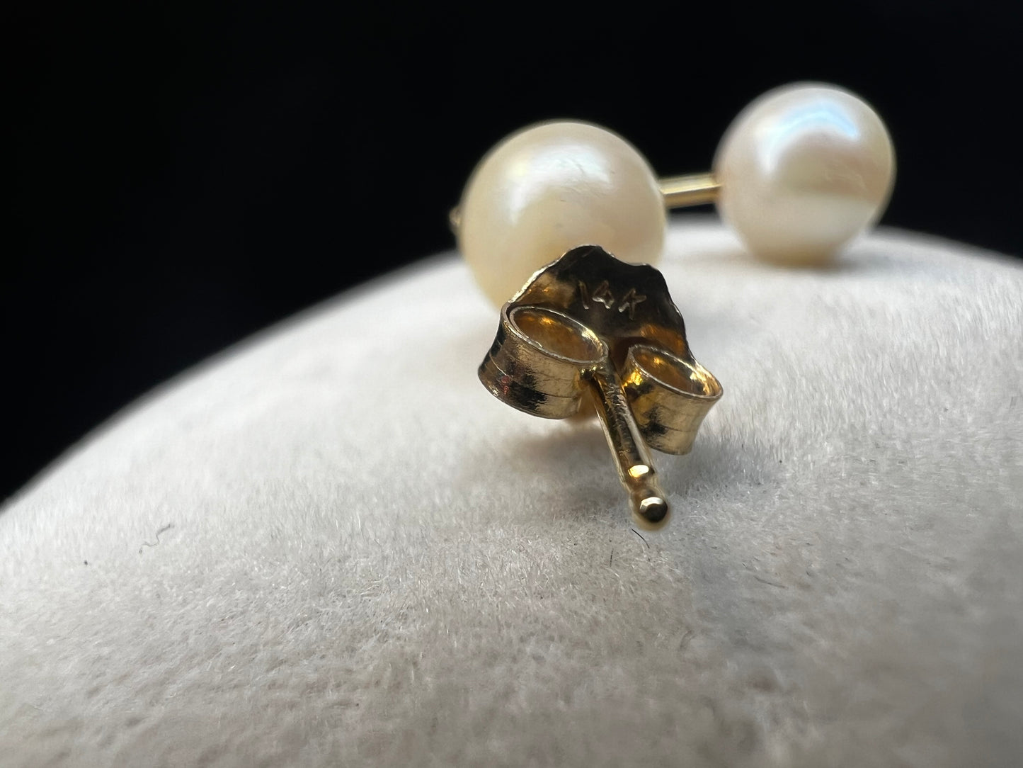 Indulge in this classic pair of pearl earrings with 14 karat gold studs and backings. They are perfect for any occasion.