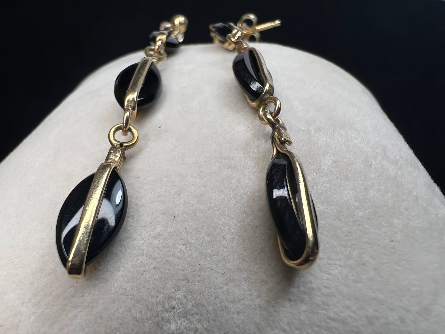 Crafted from 14 karat gold, the 2" length of these earrings will add some movement to your outfit.