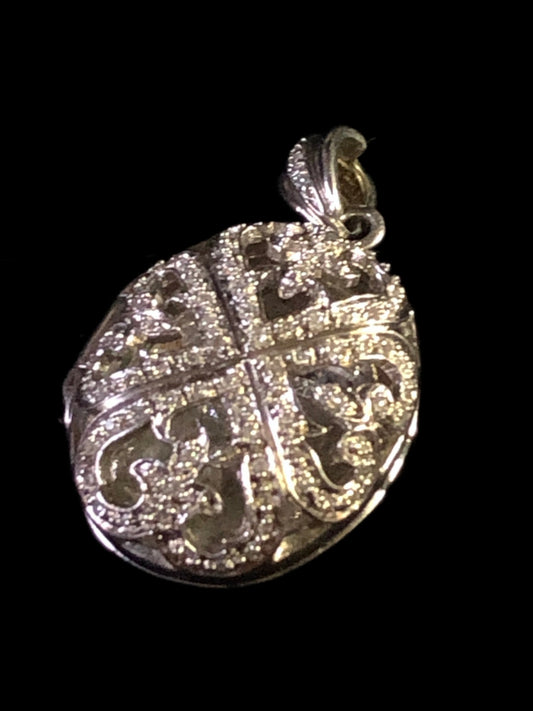 This is a lovely sterling silver locket pendant ready to adorn a necklace. The diamond accents make this piece a sparkling statement.