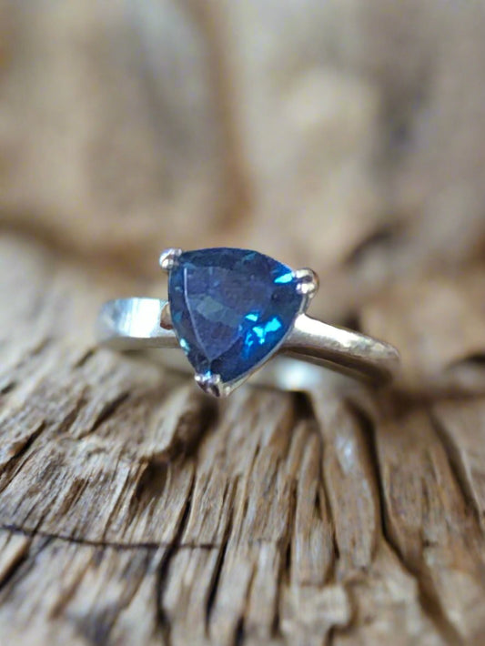 This sterling silver ring showcases a beautiful blue spinel in a trilliant (triangle) cut. The hue of the stone and its bold design will add an eye-catching flash of color to your outfit.