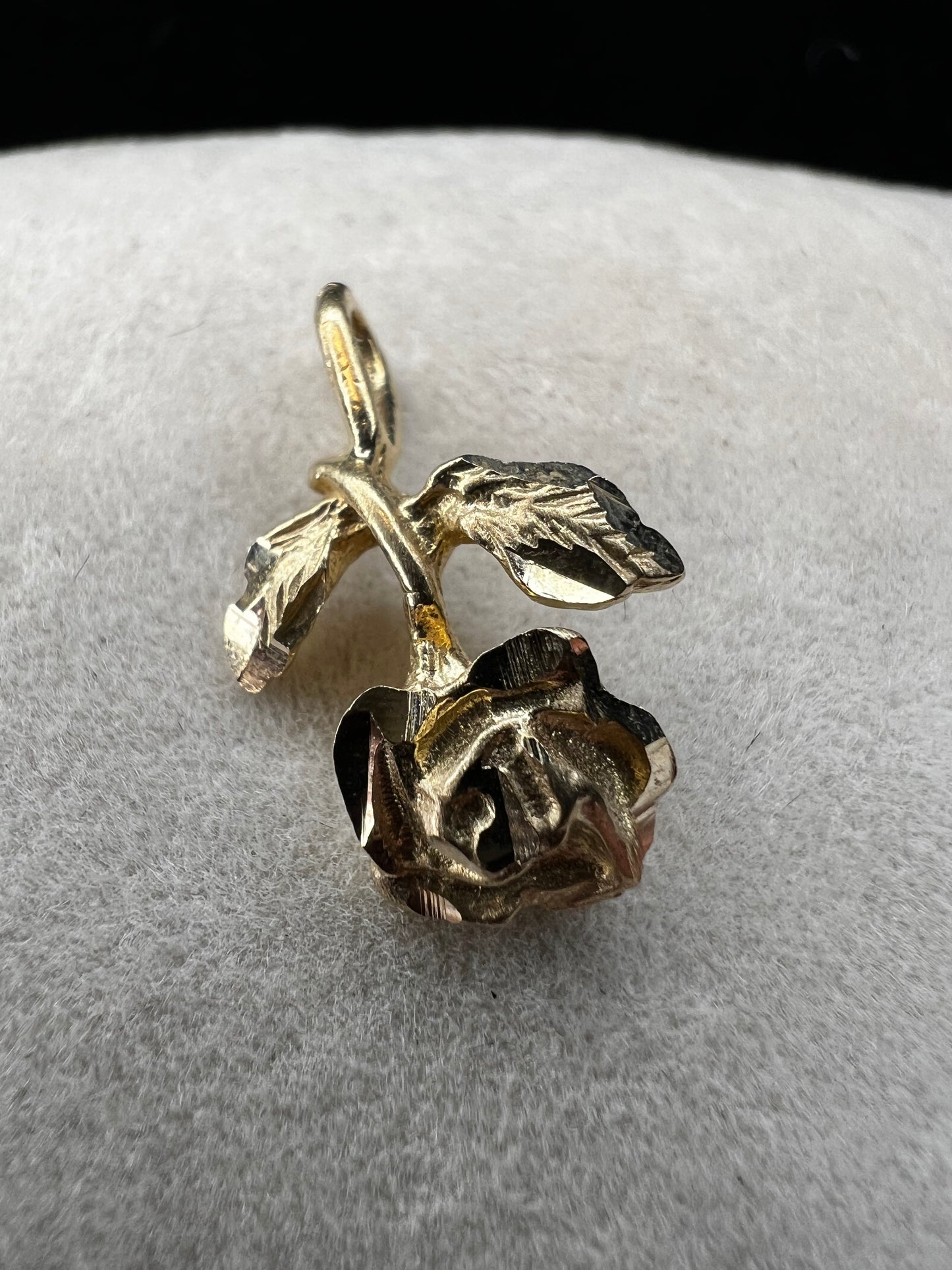 Expertly crafted from one solid piece of 14 karat gold, this pendant features a stunning flower and bail designed to last.