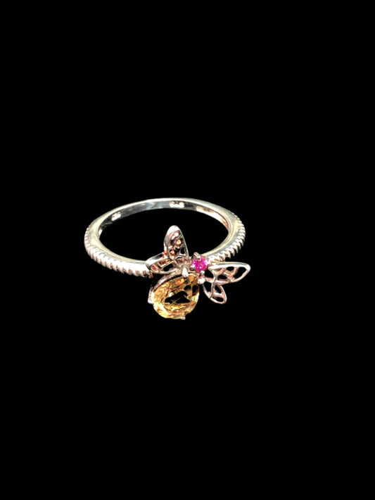 This sterling silver ring is the perfect standout accessory. It features a colorful flying insect, whose body is a citrine and its head, a ruby.