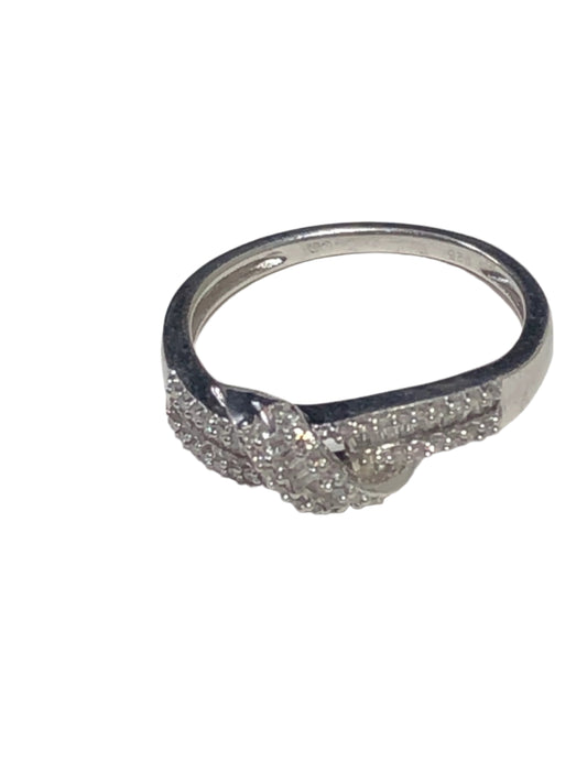 This stunning sterling silver ring boasts dazzling diamonds in an elegant setting. Some of the diamonds are marquee-cut, and others are square. The ring's delicate yet bold design makes it a unique way to show off your style.