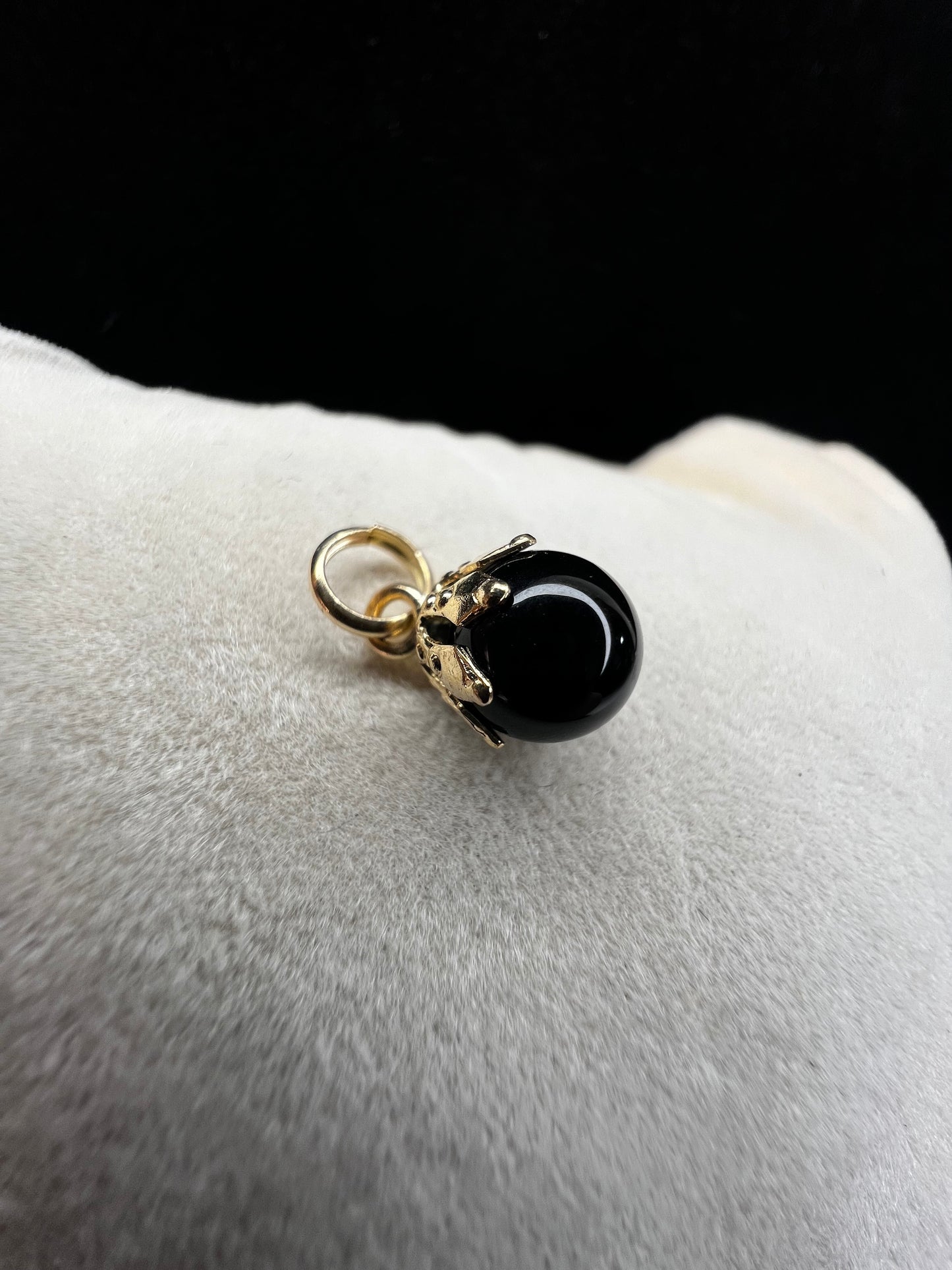 This piece is a nice addition to a charm bracelet, or as a small pendant on a gold chain necklace. It features an onyx with a 14 karat setting and jump ring.