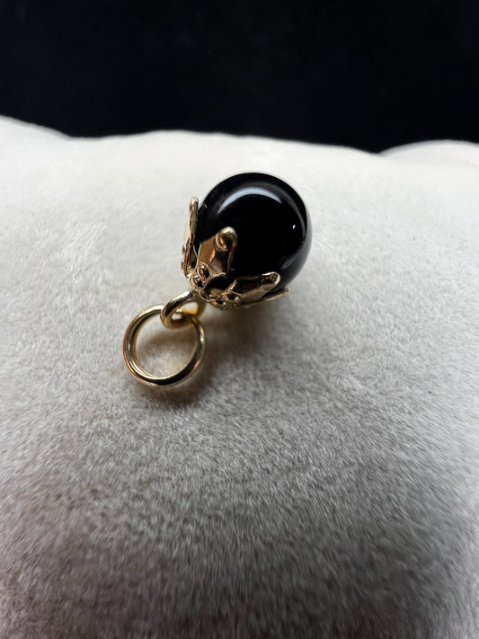This piece is a nice addition to a charm bracelet, or as a small pendant on a gold chain necklace. It features an onyx with a 14 karat setting and jump ring.