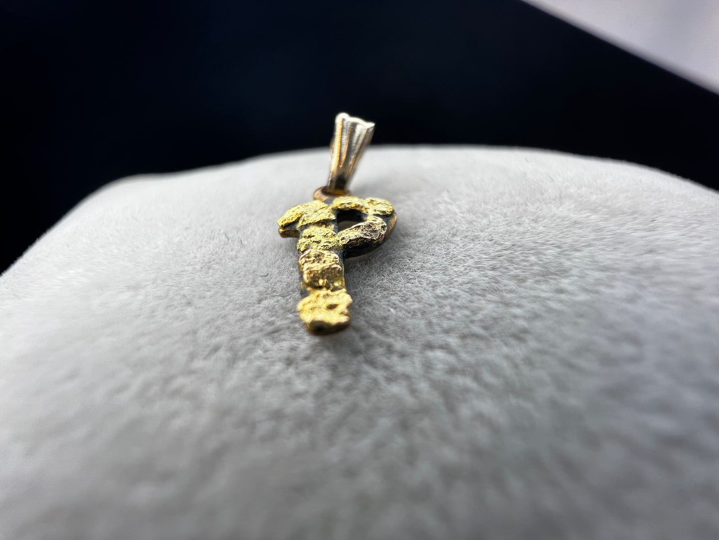 This small vintage pendant screams individuality. The "P" is crafted from brass with solid 24 karat gold nuggets attached to the front of it.