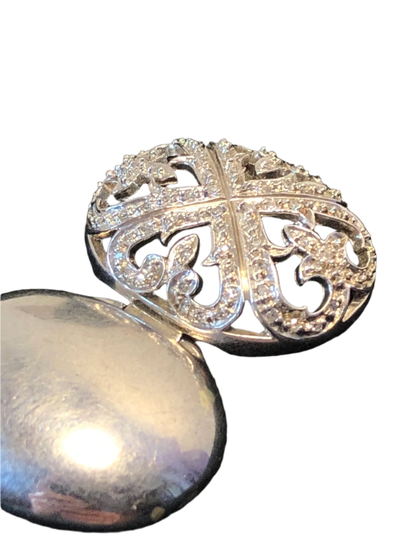 This is a lovely sterling silver locket pendant ready to adorn a necklace. The diamond accents make this piece a sparkling statement.