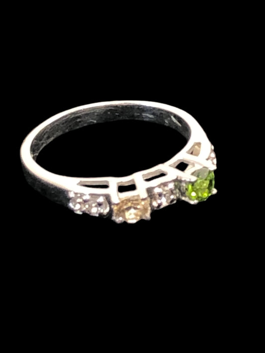 This is a sterling silver ring featuring natural gemstones (green, yellow and white/clear). It's a nice look for everyday wear or for special occasions.