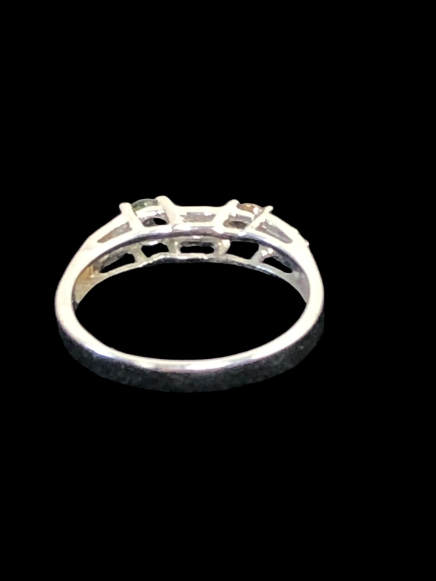 This is a sterling silver ring featuring natural gemstones (green, yellow and white/clear). It's a nice look for everyday wear or for special occasions.