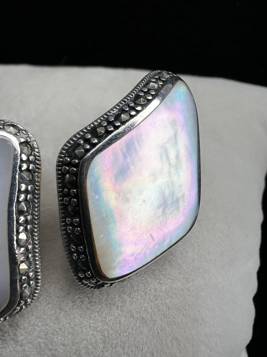 These vintage beauties are sure to stand out. They are crafted from mother of pearl, sterling silver and marcasite.