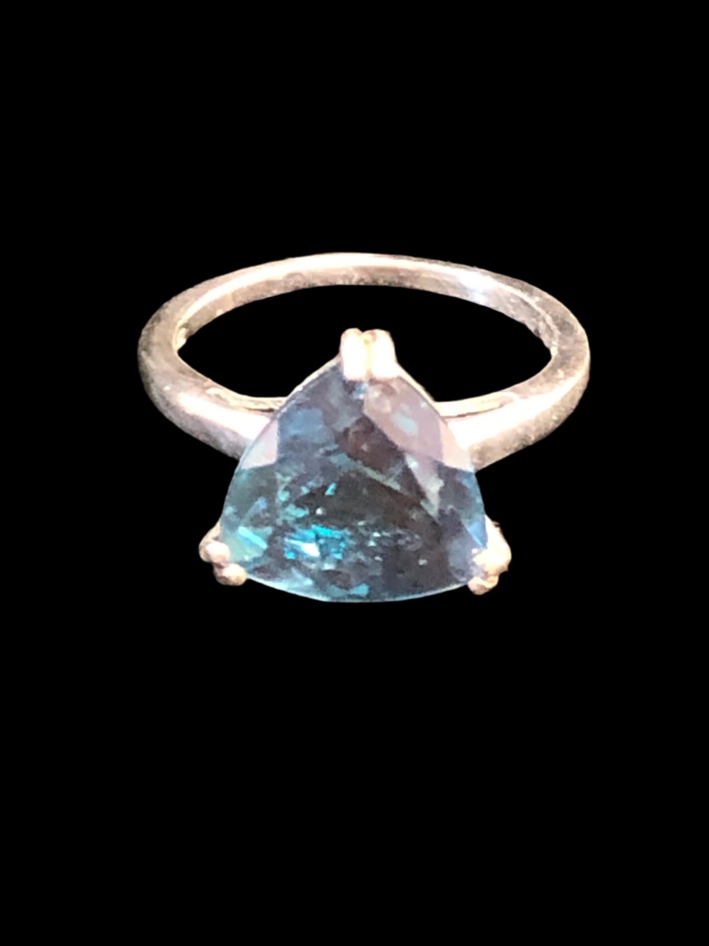 This sterling silver ring showcases a beautiful blue spinel in a trilliant (triangle) cut. The hue of the stone and its bold design will add an eye-catching flash of color to your outfit.