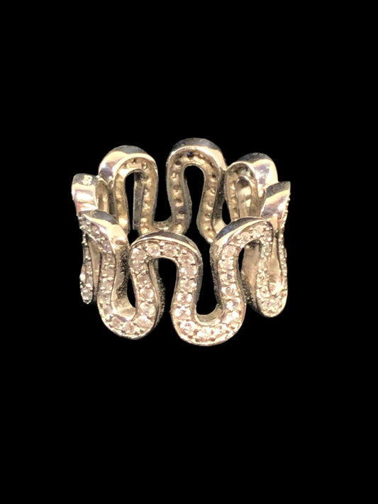 This ring oozes imaginative individuality. The band boasts a snaking line of clear glass stones diamonds against fine sterling silver.