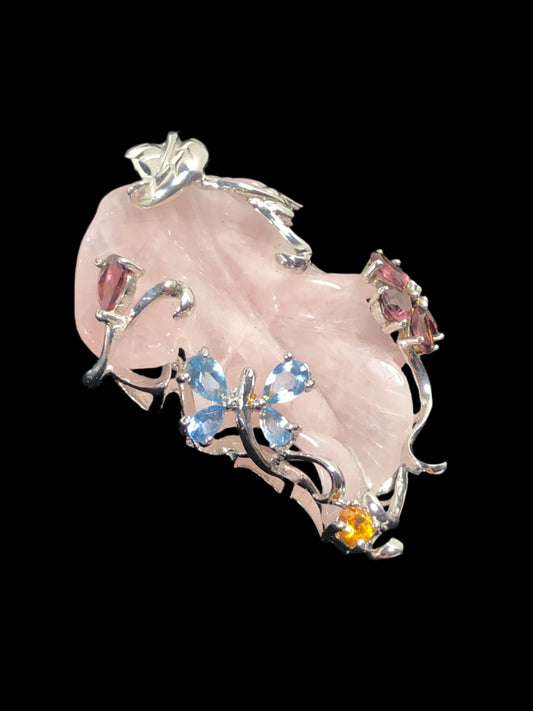 This exquisite pendant showcases a meticulously hand-carved pink jade leaf, which is encased in ornately crafted sterling silver. The glass stone accents -- including one shaped as flower and another, a butterfly -- add sparkling color to this unique piece.
