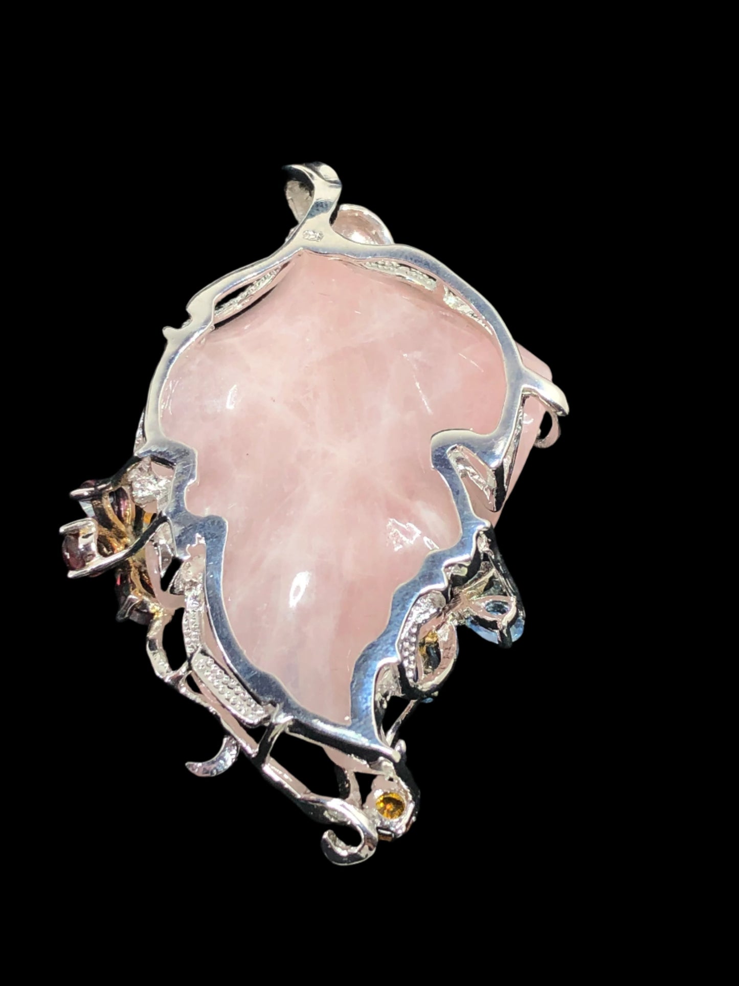 This exquisite pendant showcases a meticulously hand-carved pink jade leaf, which is encased in ornately crafted sterling silver. The glass stone accents -- including one shaped as flower and another, a butterfly -- add sparkling color to this unique piece.