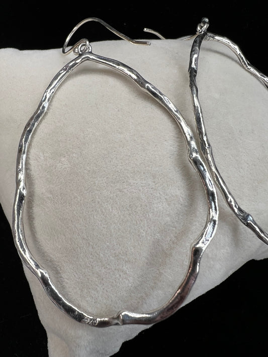 These hammered and scalloped sterling silver earrings will add a bit of flash to your outfit.