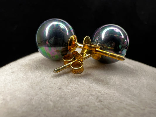 The Tahitian pearl is a great way to give a different look to a classic pair of earrings. Set with gold over sterling silver, the metallic blues and greens of these beauties will add pizzazz to any outfit.