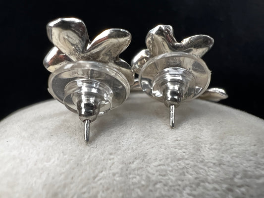 Add some floral charm to your outfit with these beautiful sterling silver earrings. One flower is attached to the post and another dangles, providing some gentle movement.
