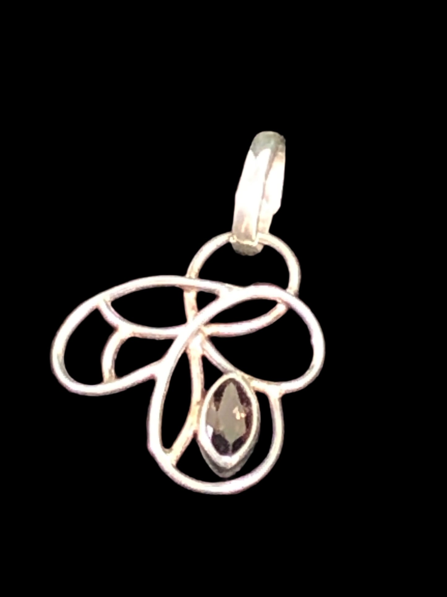 Embrace your individuality with this beautiful sterling silver pendant. With an artistic flowing design, this piece features a spinel stone with rich brown hues.