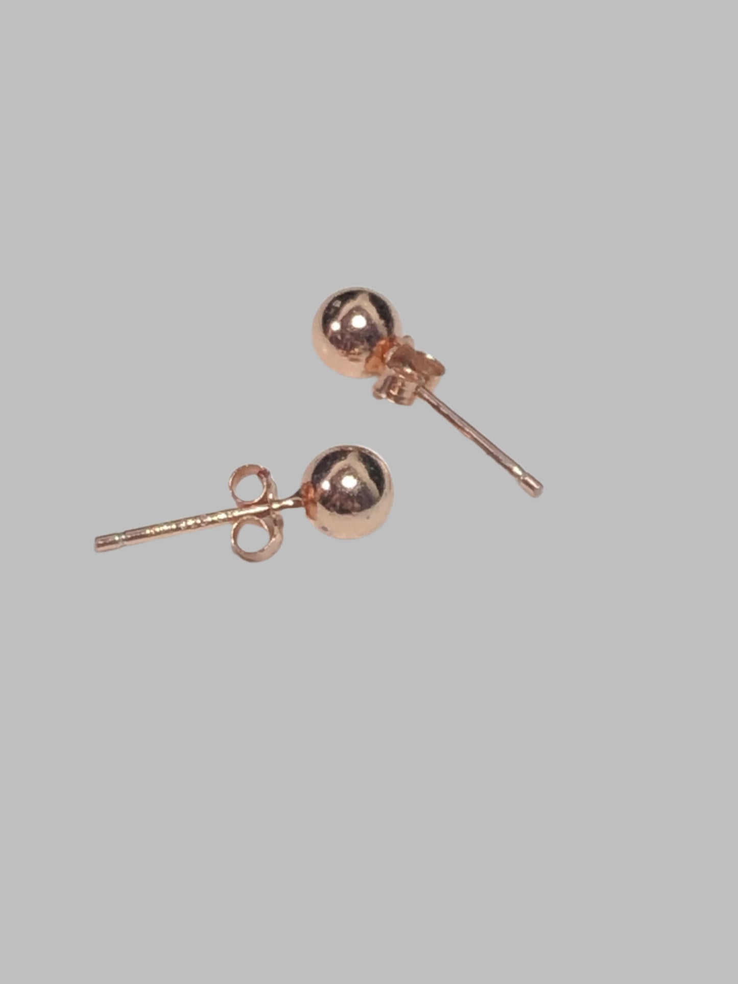 This lovely pair of stud earrings features luxurious rose gold overlaid on sterling silver. The dainty size is perfect for accessorizing any outfit with a touch of sophistication and style.