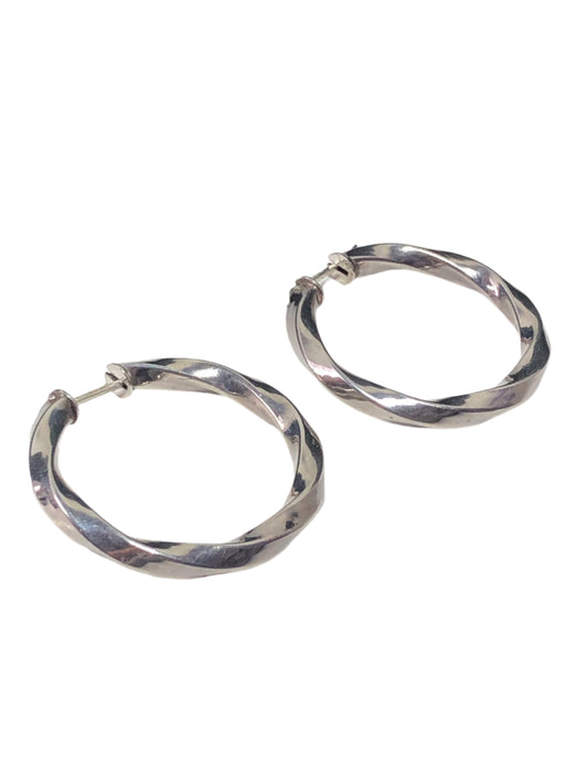 Add a touch of elegance to your outfit with these vintage earrings. They feature a smooth design of gently twisting sterling silver, creating a shifting shine.
