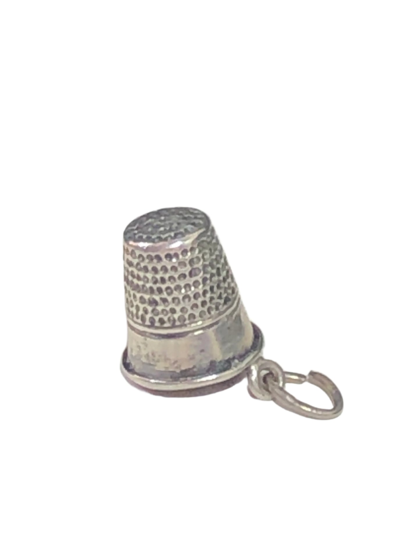 Indulge in this adorable vintage thimble charm made from sterling silver. Perfect for sewing enthusiasts.