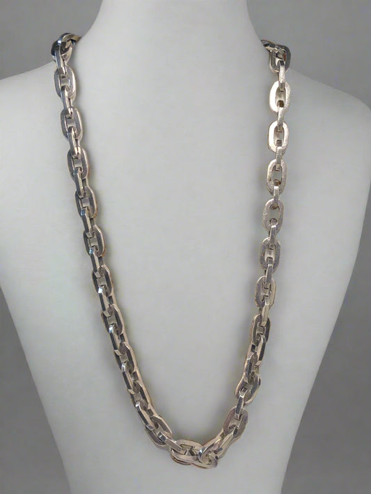 This vintage large-link sterling silver chain necklace is sure to make a statement. It will add a luxurious element to any outfit.