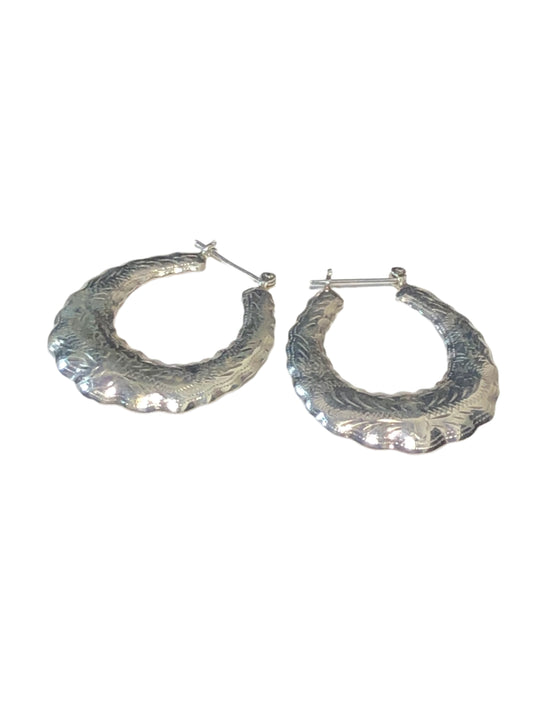 Add a touch of elegance to your look with our vintage sterling silver hoop earrings. These beauties are lightweight and feature intricate etched designs on both sides.