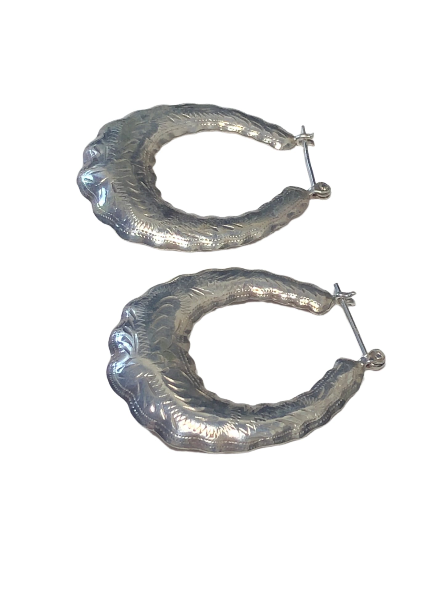 Add a touch of elegance to your look with our vintage sterling silver hoop earrings. These beauties are lightweight and feature intricate etched designs on both sides.