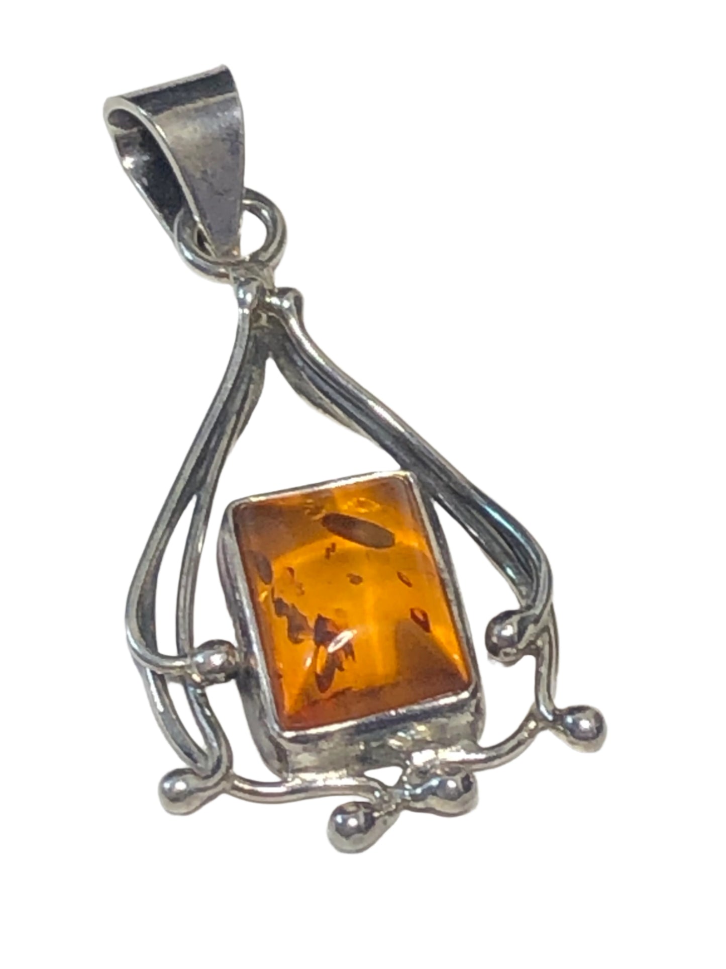 Indulge in the elegance of this vintage sterling silver pendant. It features an amber stone in a setting made with excellent craftsmanship.