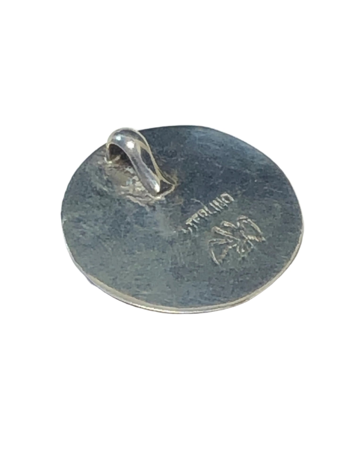 Keep a bit of sunshine close to you with this unique vintage pendant. Surrounded by sterling silver, the inlaid mother-of-pearl and turquoise chips create a vibrant sunrise scene.