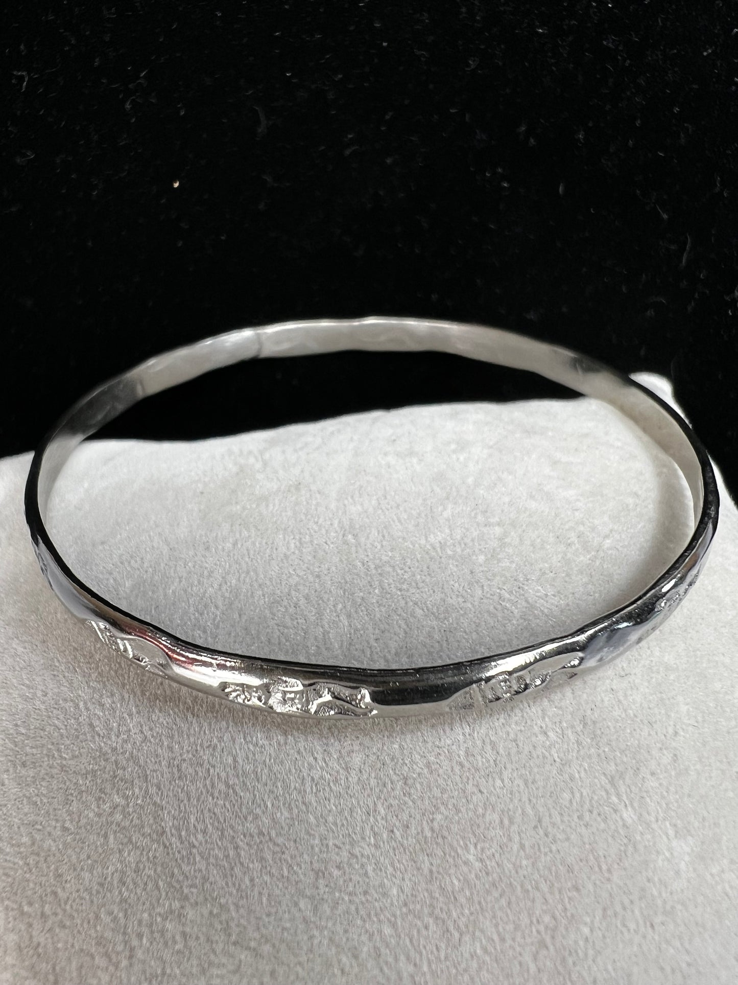 This sterling silver bangle bracelet is perfect for any outfit. It has designs around the entire outside and Mexican hallmarks on the inside.