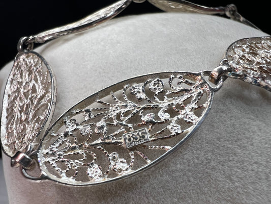 This is a beautiful early vintage filigree bracelet, crafted with intricate detail. Made from .835 silver, this piece will add elegance to your look.