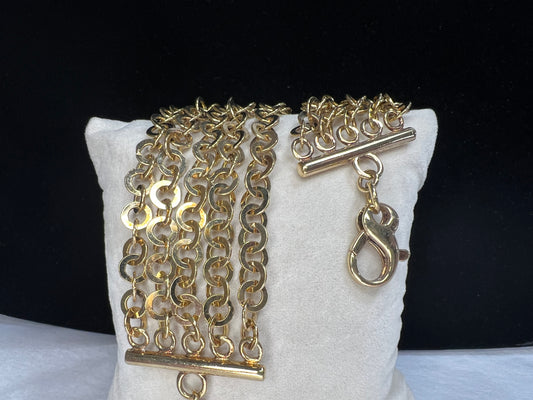 Here is a beautiful piece crafted from sterling silver and overlaid with gold. The five strands of this chain link bracelet will dance in any light. Signed Milor Italy.