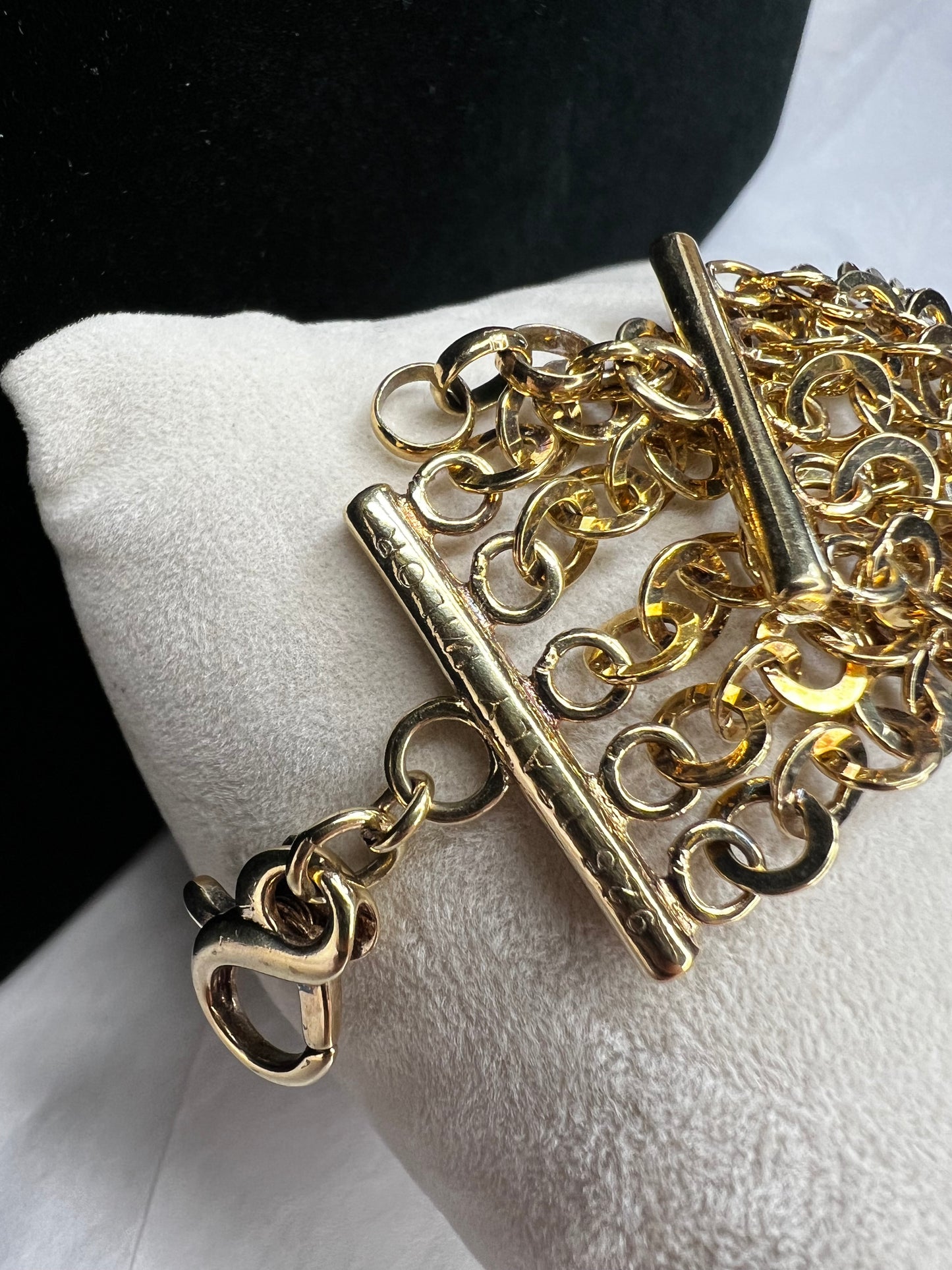 Here is a beautiful piece crafted from sterling silver and overlaid with gold. The five strands of this chain link bracelet will dance in any light. Signed Milor Italy.
