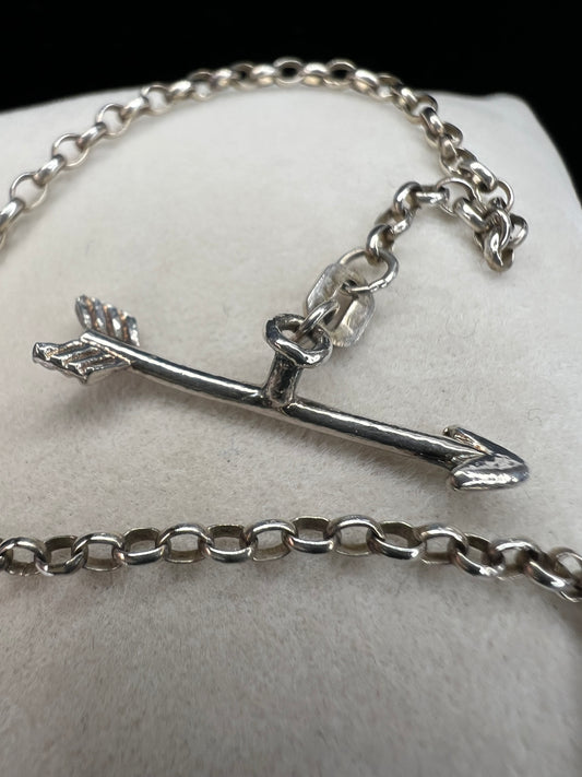 This is a petite, lovely sterling silver bracelet. The arrow goes through the heart, creating a secure closure.