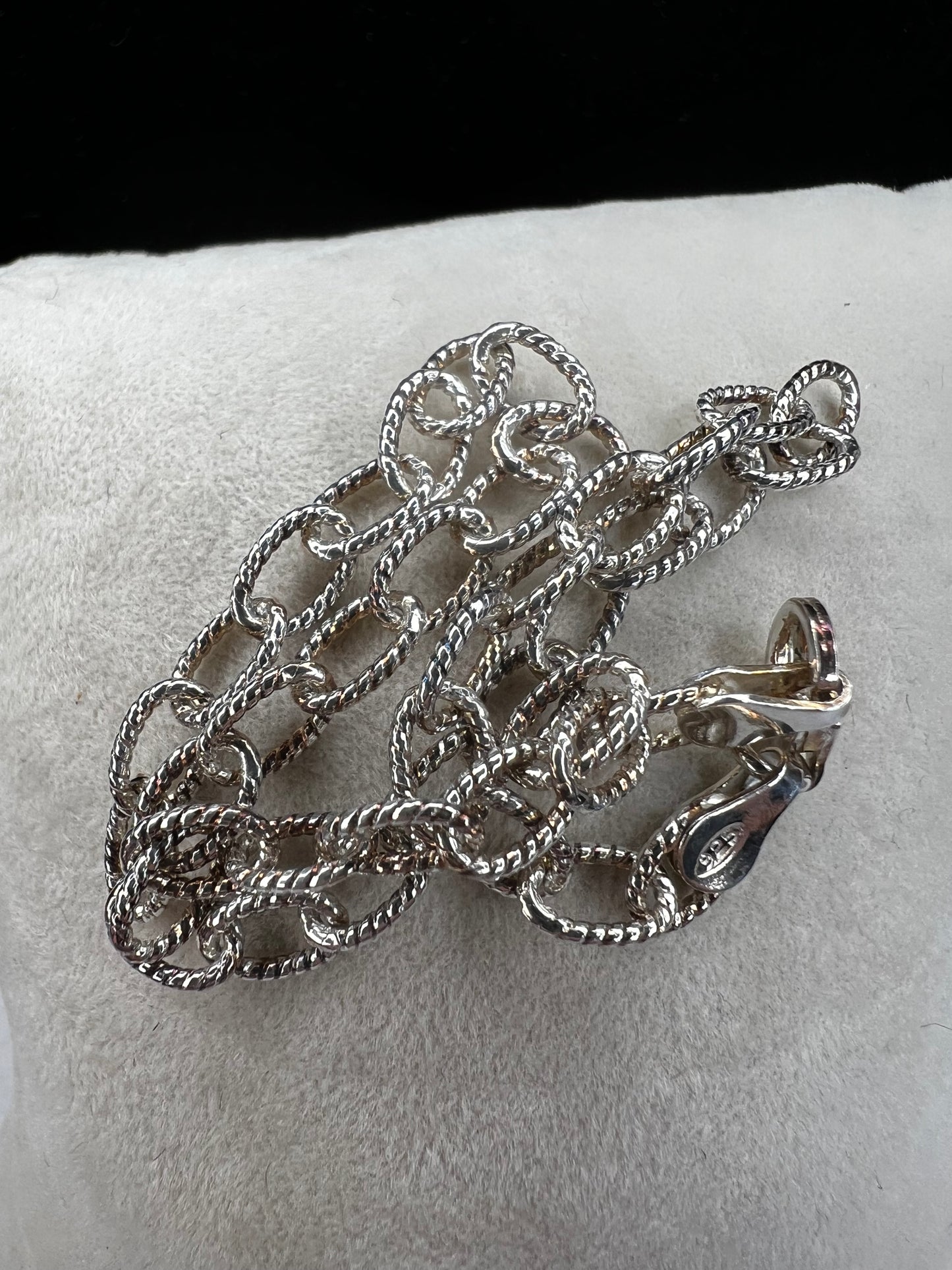 This sterling silver bracelet is designed with oval twisted chain links, which provides more shine and movement.