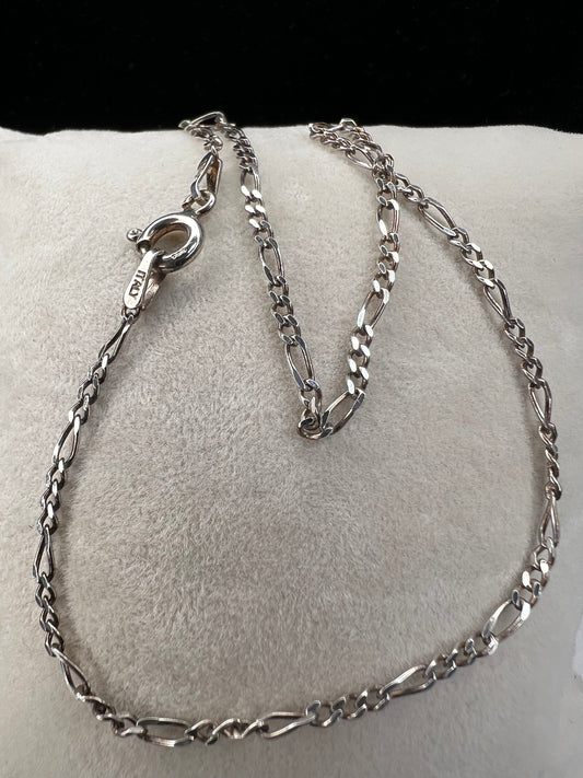 Add some vintage charm to your outfit with this dainty sterling silver bracelet. It features a classic figaro link, giving it timeless appeal.