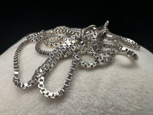 Enhance your style with our sterling silver thin box chain necklace. Perfect for day or night, this petite chain adds a touch of elegance to any outfit.