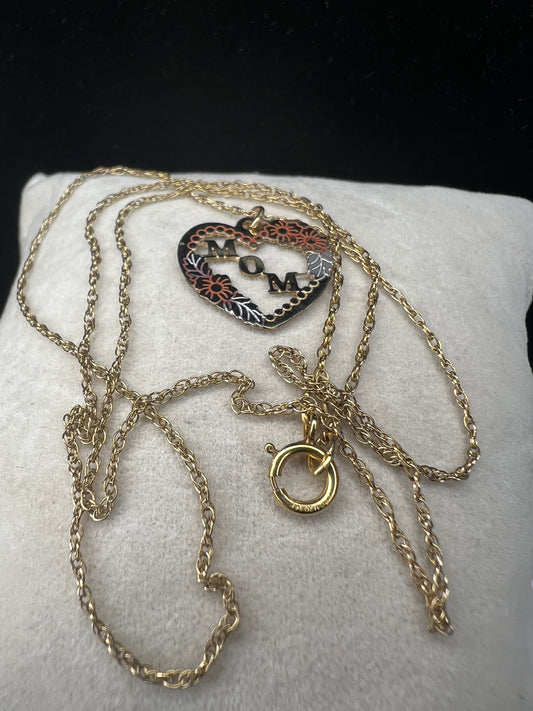 Show your mom some love with our 14 karat gold filled chain necklace and heart pendant. The chain features sturdy links with a delicate look, and the pendant has a touch of color through some enamel on the flower and silver leaves.