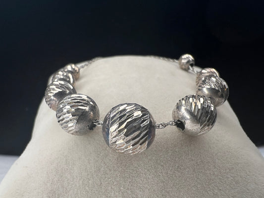 Elevate your style with our vintage sterling silver necklace. It features graduating diamond cut sterling silver beads on a long thin chain.