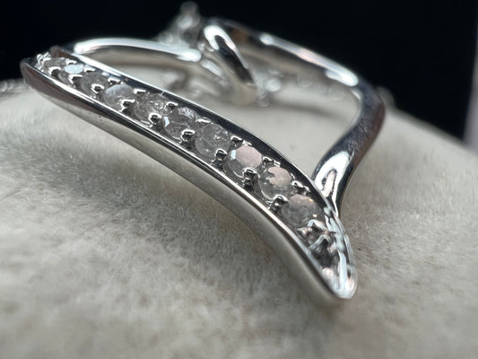 This delicate sterling silver chain holds a beautiful sterling heart pendant, accented with sparkling diamonds along one side. Perfect for adding a touch of elegance to any outfit.