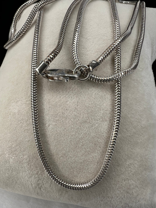 Elevate your everyday look with our elegant sterling silver round snake chain. This solid chain is versatile and ready to be paired with your favorite pendant or slide charm, adding a touch of sophistication to any outfit.