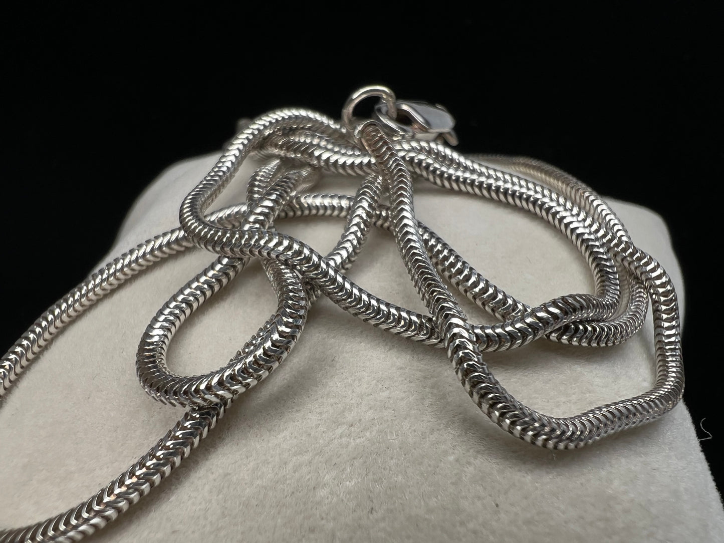 Elevate your everyday look with our elegant sterling silver round snake chain. This solid chain is versatile and ready to be paired with your favorite pendant or slide charm, adding a touch of sophistication to any outfit.