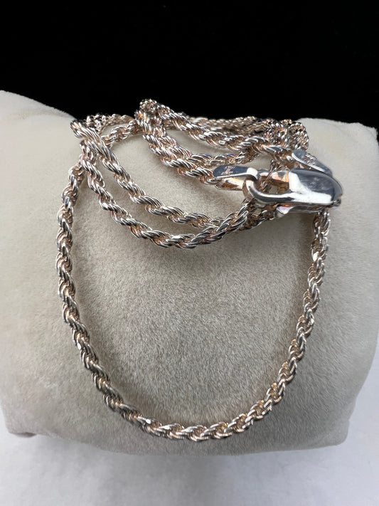 This long, thin sterling silver rope chain necklace exudes elegance and sophistication. Perfect for everyday wear or special occasions.