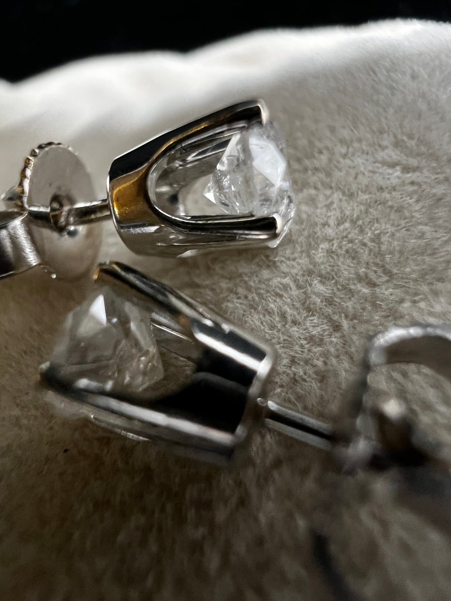 This is a unique pair of clear white galaxy diamonds set in 14 karat white gold. Galaxy diamonds have a celestial appearance due to numerous inclusions. These are natural, untreated diamonds.